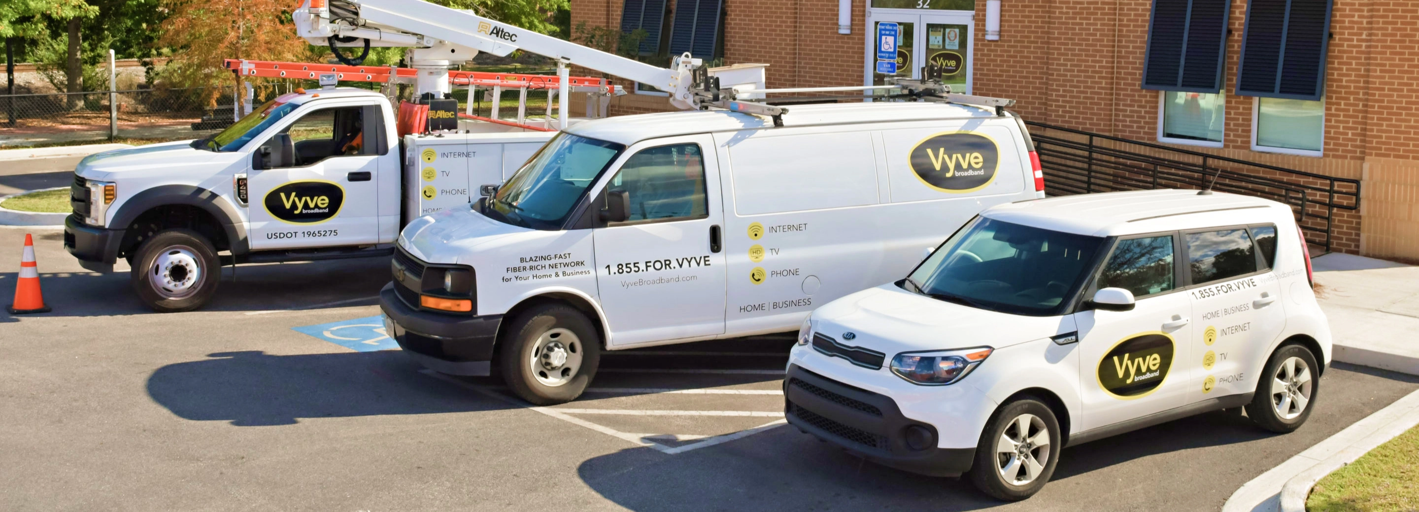 Three fleet vehicles: a van, truck, and small suv.