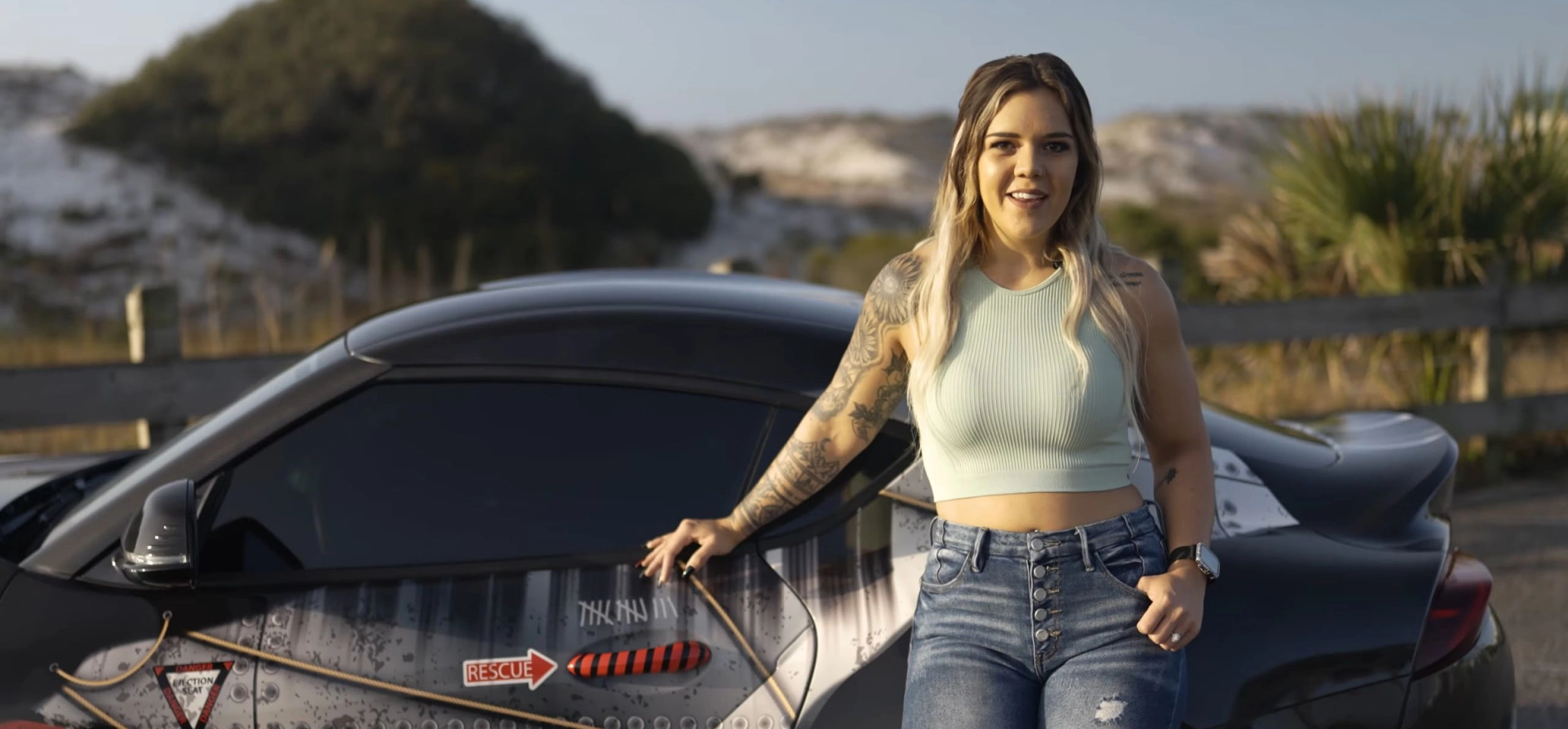 Woman standing in front of wrapped car with bolts and vintage design